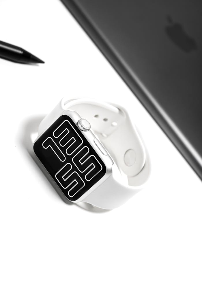 services-img A sleek white smartwatch with a digital display on a minimalist desk setup.