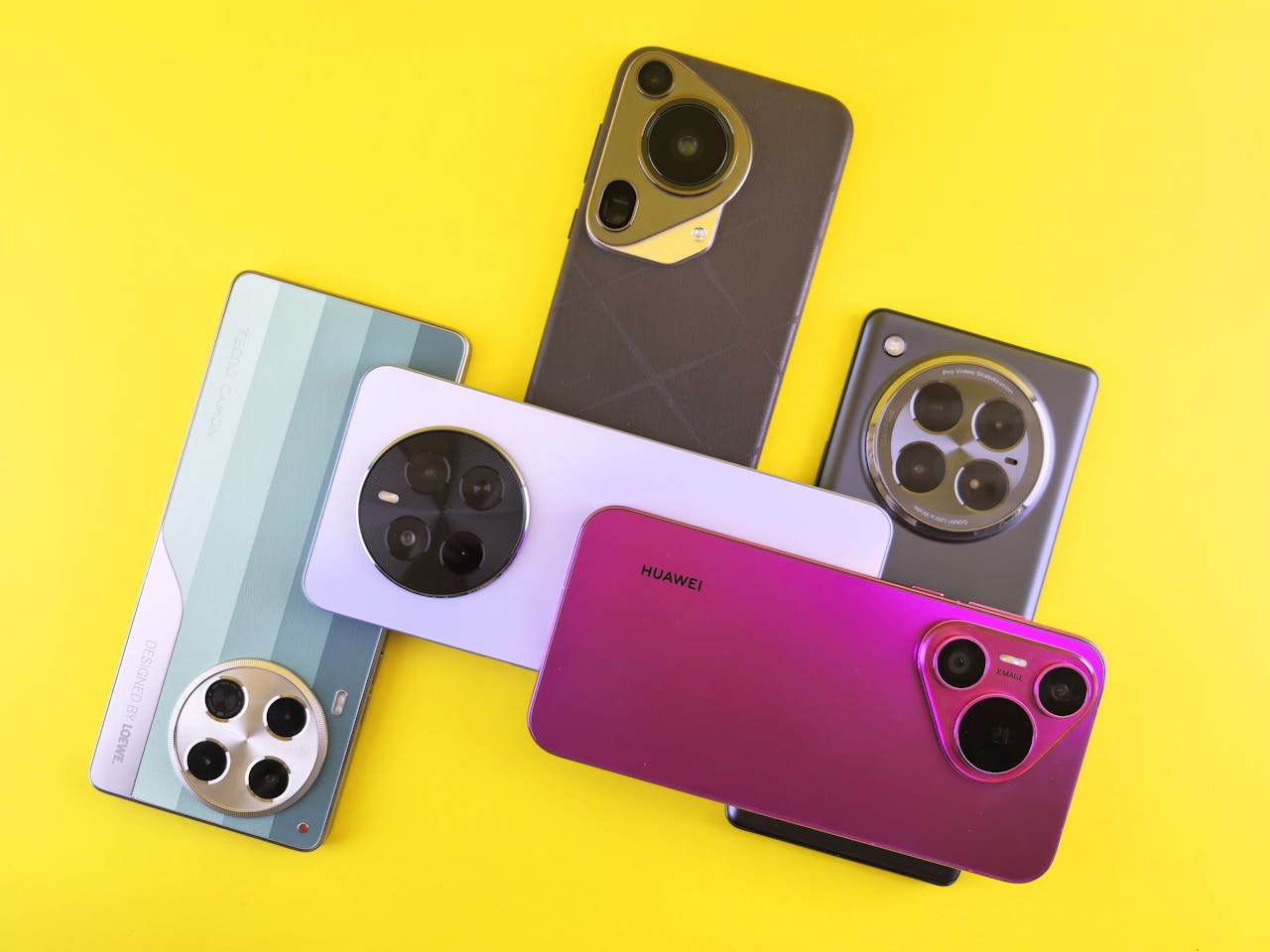 about-img A collection of colorful smartphones arranged on a bright yellow background, showcasing modern design.