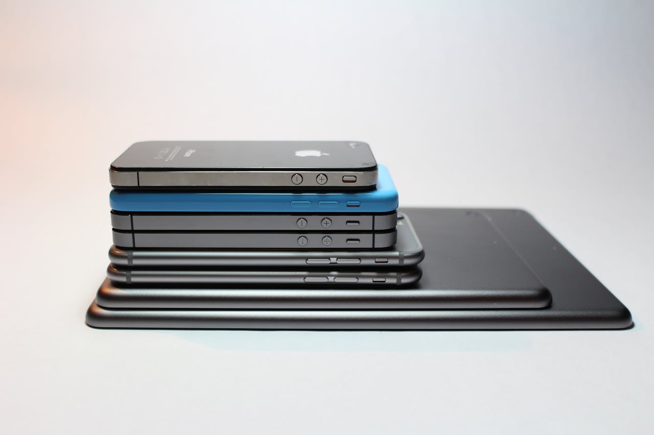 services-01 Stacked modern smartphones and tablets showcasing sleek design. Perfect tech background.