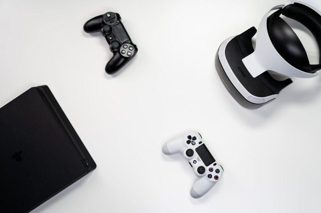 The Art of Drawing Readers In: Your attractive post title goes here Flat lay of gaming console, controllers, and VR headset on a white background.