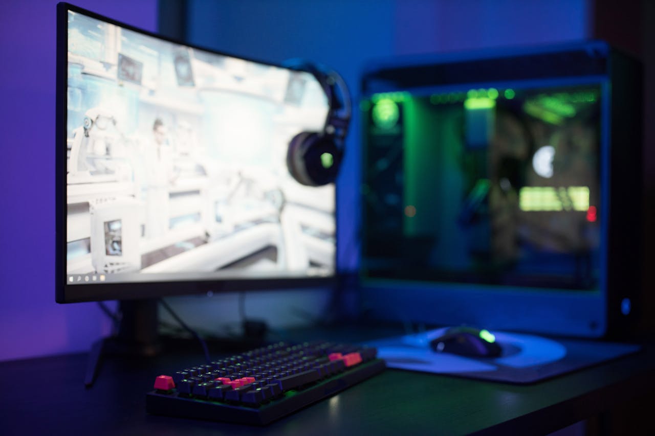 vision High-tech gaming setup featuring a curved monitor, RGB keyboard, and vibrant lighting.