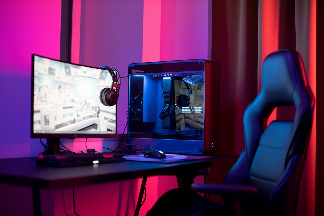 journey-02 A sleek gaming setup featuring a high-end PC, widescreen monitor, and ergonomic chair lit by neon lights.